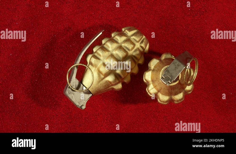 MK2 hand grenades. Two golden pineapple grenades on the red velvet