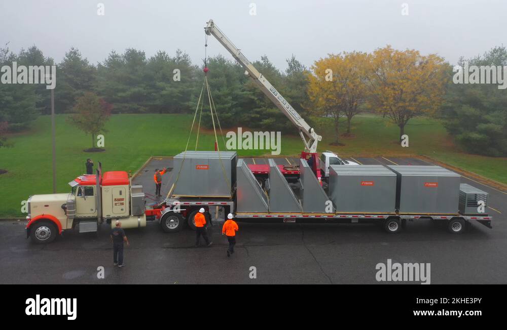 Crane Hoist Large Commercial Air Conditioner Units Off The Flatbed Tru