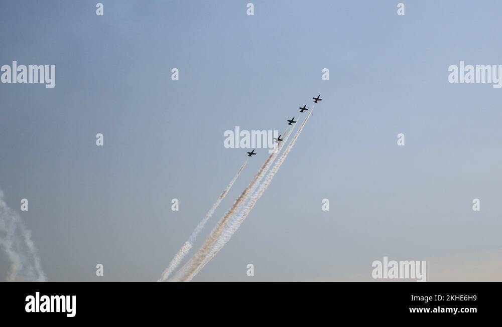 Blue sky Five planes fly upward Diverging to the sides Leave a mark