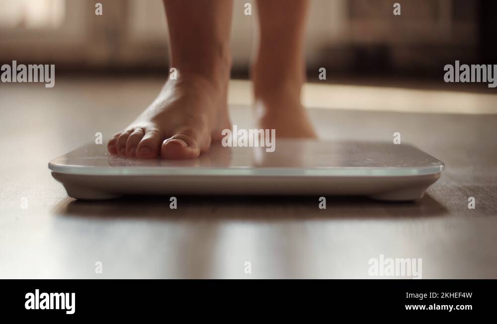 Woman On Scales Measure Weight.Legs On Bathroom Scale.Checking Body