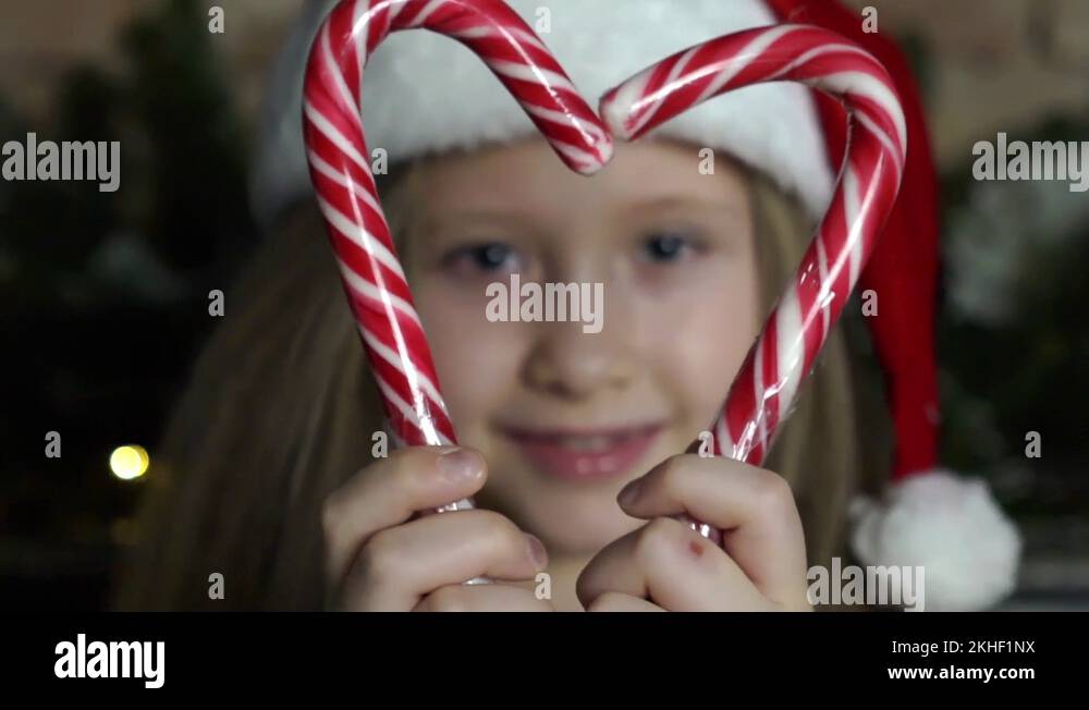 Little Girl Holding Candy Canes Together To Make A Heart Stock Video