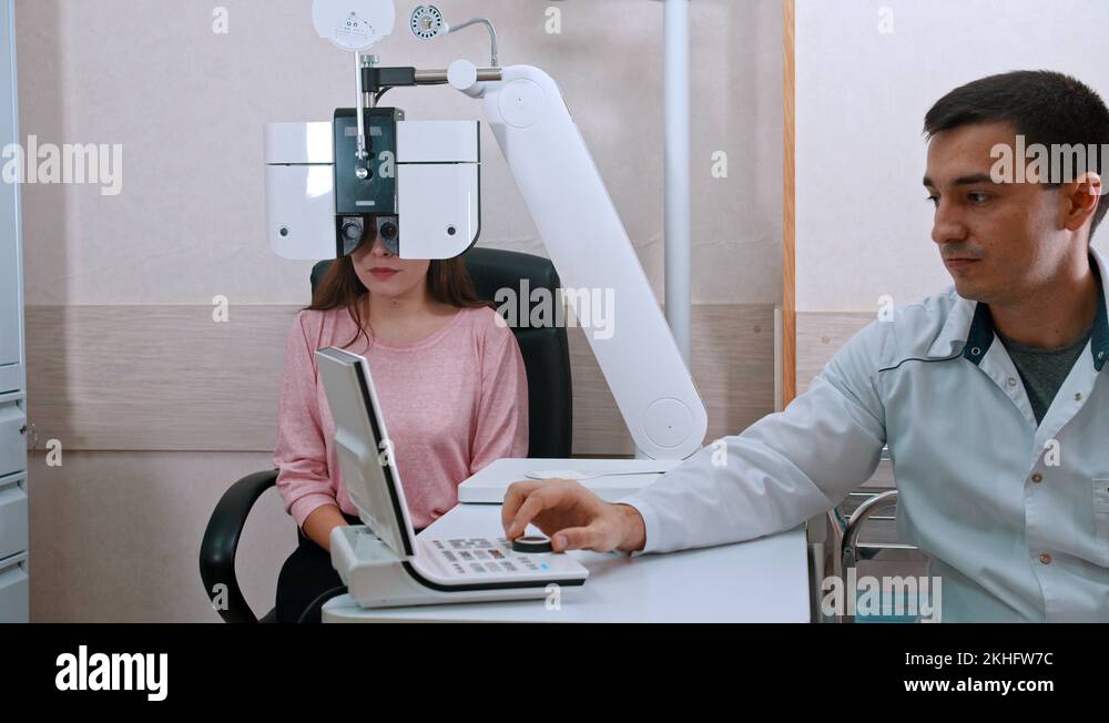 Ophthalmology treatment - young woman checking her visual acuity on an ...