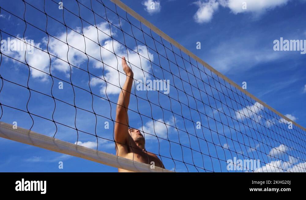 Man spiking a beach volleyball slow motion close up Stock Video Footage