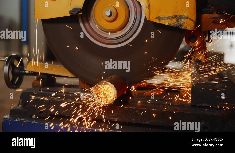 cutting of metal pipe with machine saw at plant construction Stock