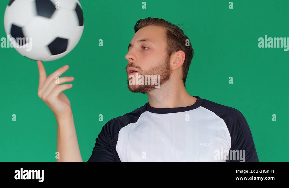 Soccer football player spinning ball on finger on green screen, 4k slow ...