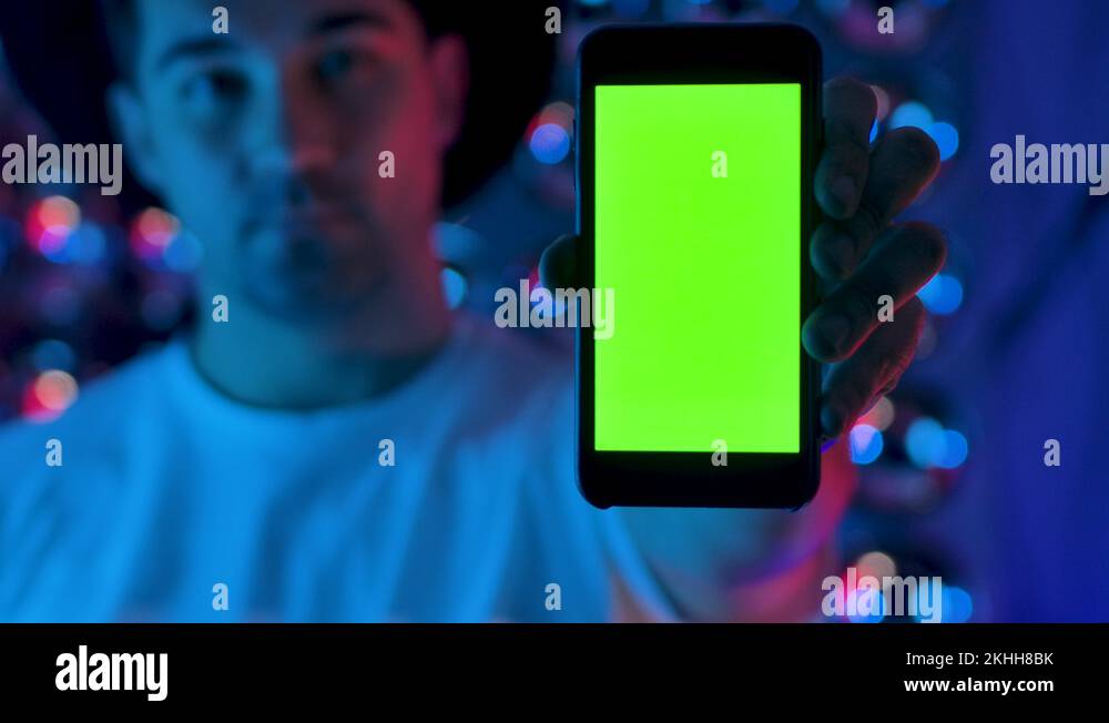 Creative Man Hand Holding a Mobile Telephone with Vertical Green Screen Mockup Stock Video
