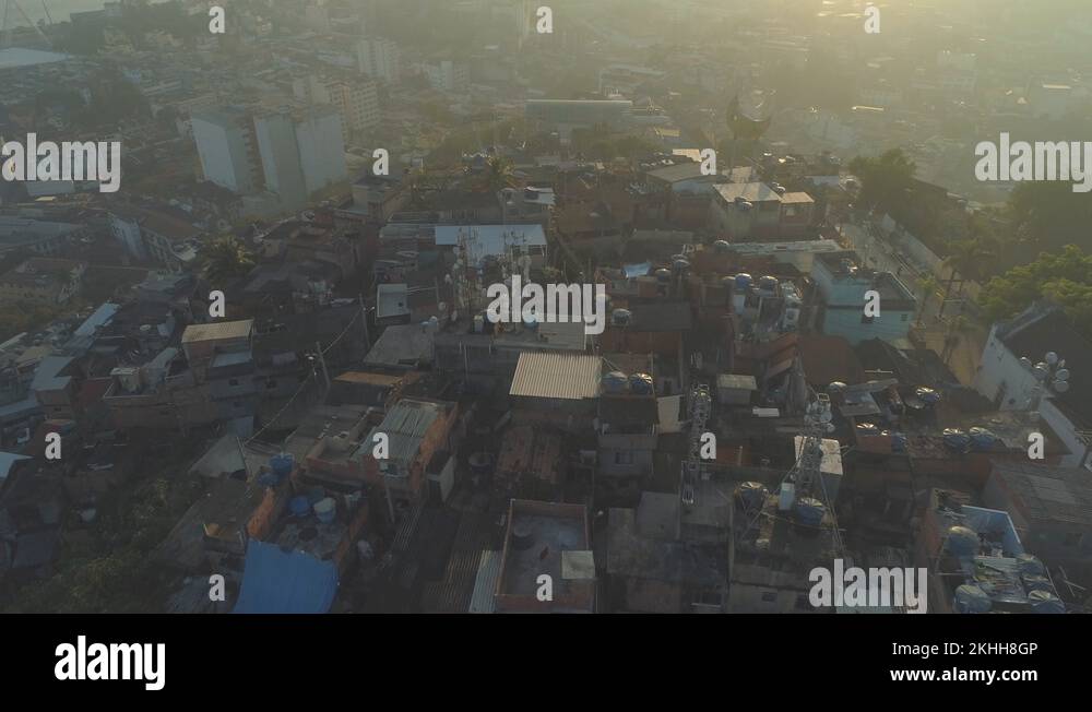 Favela Rooftops Sunrise aerial of hilltop favela pulling back over rooftops and water ...