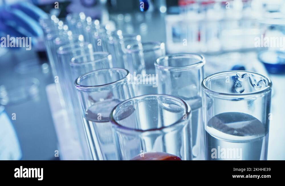 Pharmaceutics Laboratory Pipette Dropping Blue Liquid into Test Tubes, Medical Stock Video