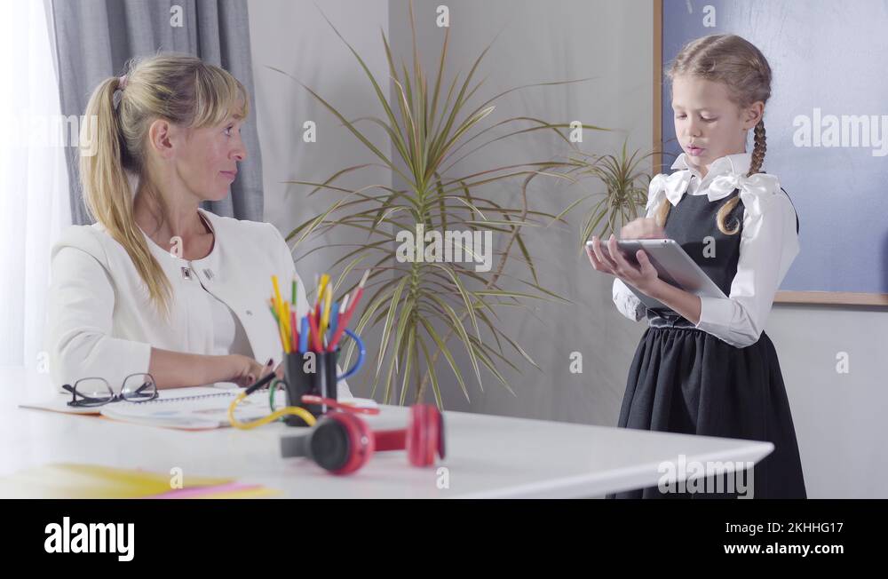 Camera approaching slowly to Caucasian girl in school uniform ...