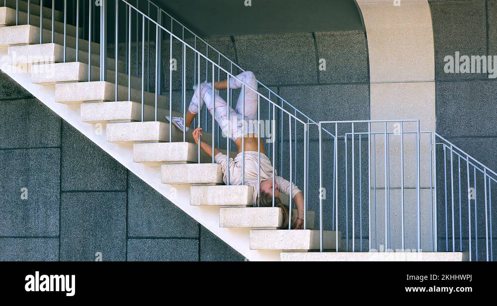 Gymnast girl performs stretching exercise on the stairs in Los Angeles