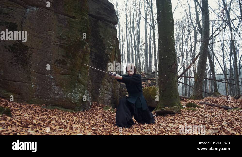 man in traditional Japanese clothes, with a sword, a katana, trains