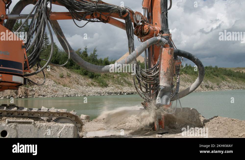 Rotary drill rig drilling blast holes for explosives in limestone