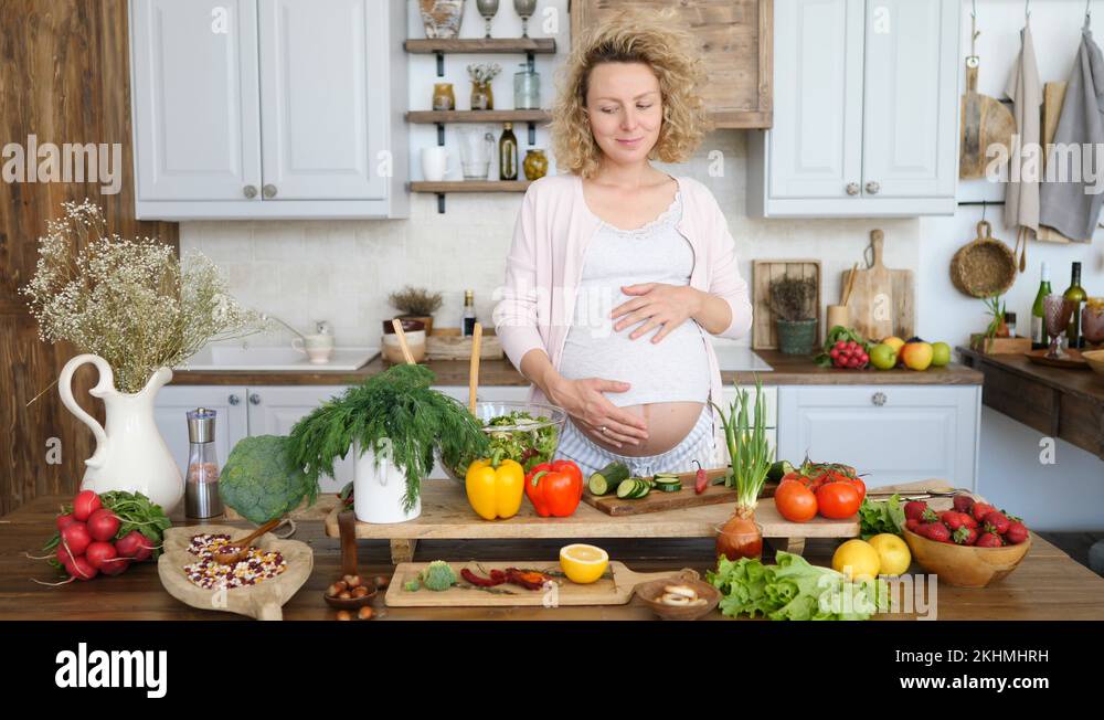Pregnant Woman Cooking Healthy Food In Kitchen. Pregnancy Diet and