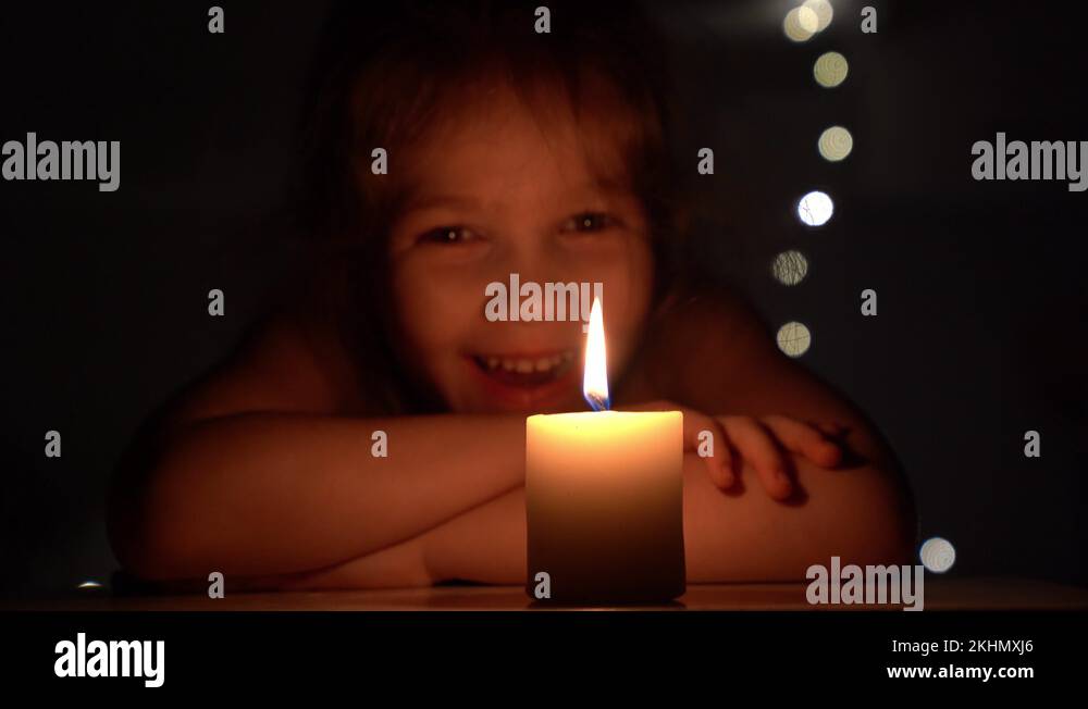 Candle in the dark and the little girl Stock Video Footage Alamy