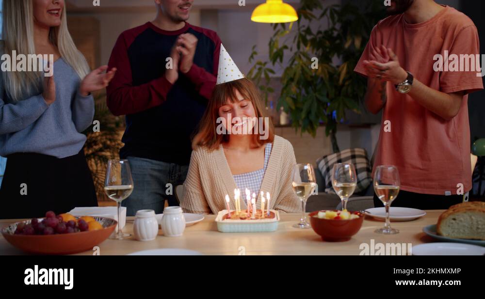 Happy Birthday of cute ginger Hispanic girl blowing out candles in