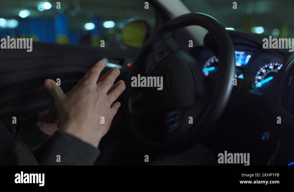 Man driving in innovative automated car using selfparking autopilot