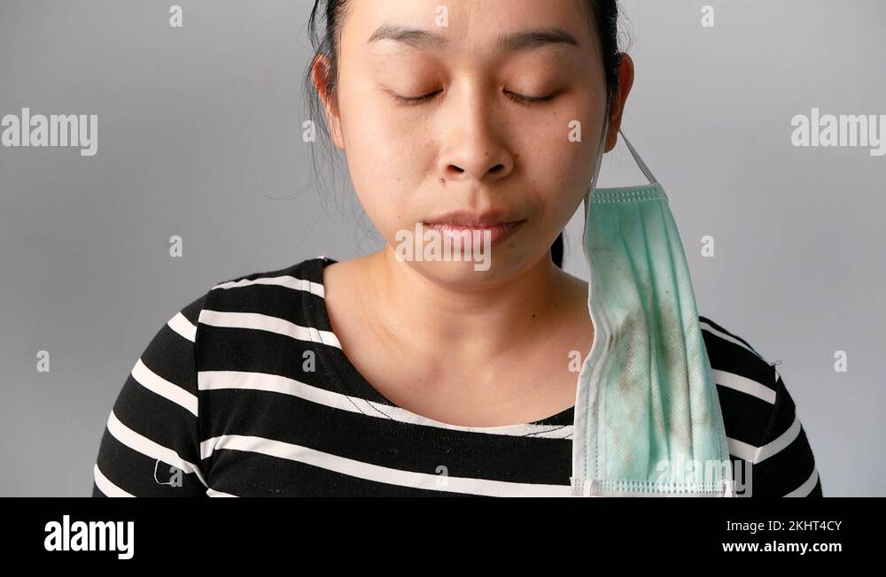 woman blowing nose in a tissue feel sick at outdoor from polluted air