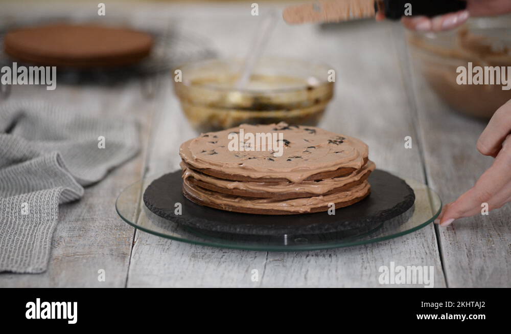 Step by step. Pastry chef making chocolate layer cake with prune