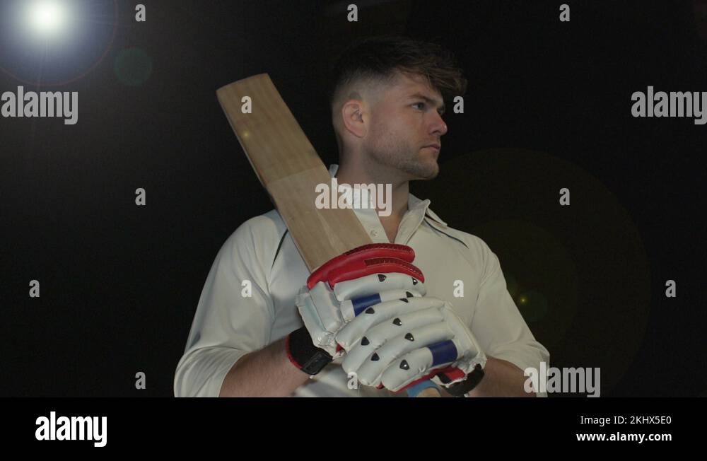 Cricket / Cricketer Portrait with the bat. Black Background. Super slow