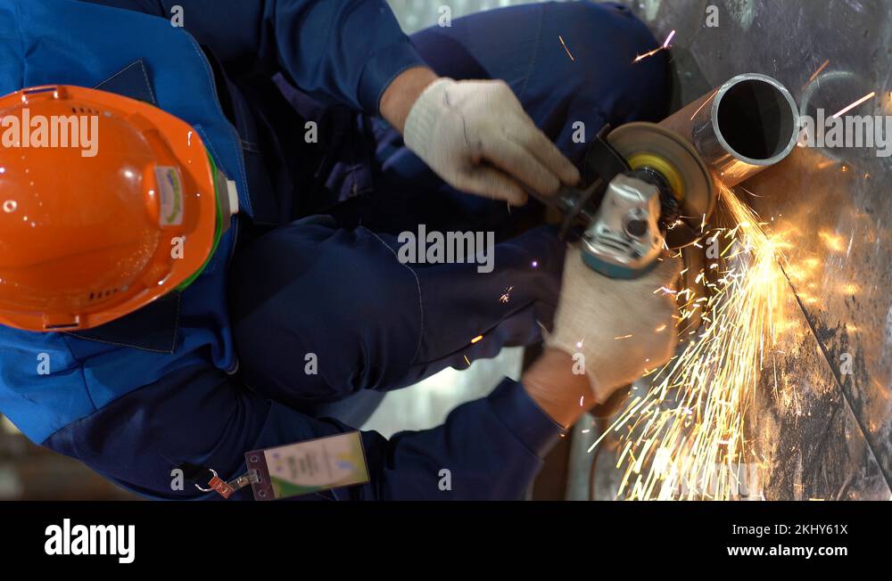 Working male use an electric tool grinder with cleaning stone installed