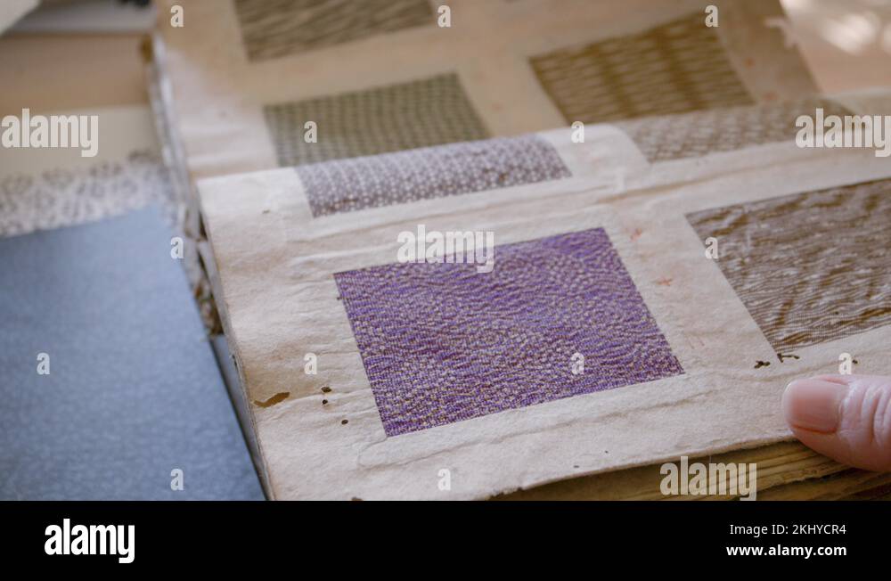 Light skinned female hand turn over pages in an old japanese book full ...