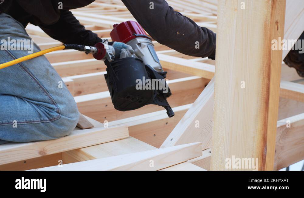 Pneumatic nailing gun or nailer used by builders at frame house