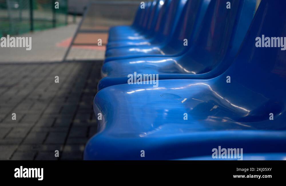 Empty blue plastic seats in outdoor sport stadium players bench Stock ...
