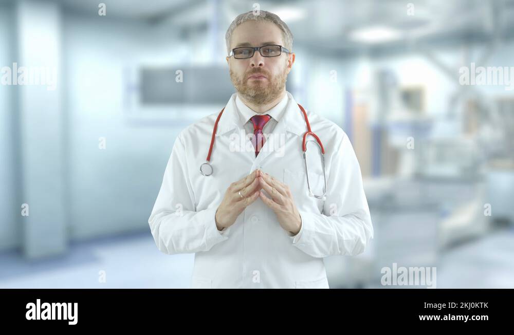 Hesitating doctor spreads his hands in the modern hospital. Shot on Red ...