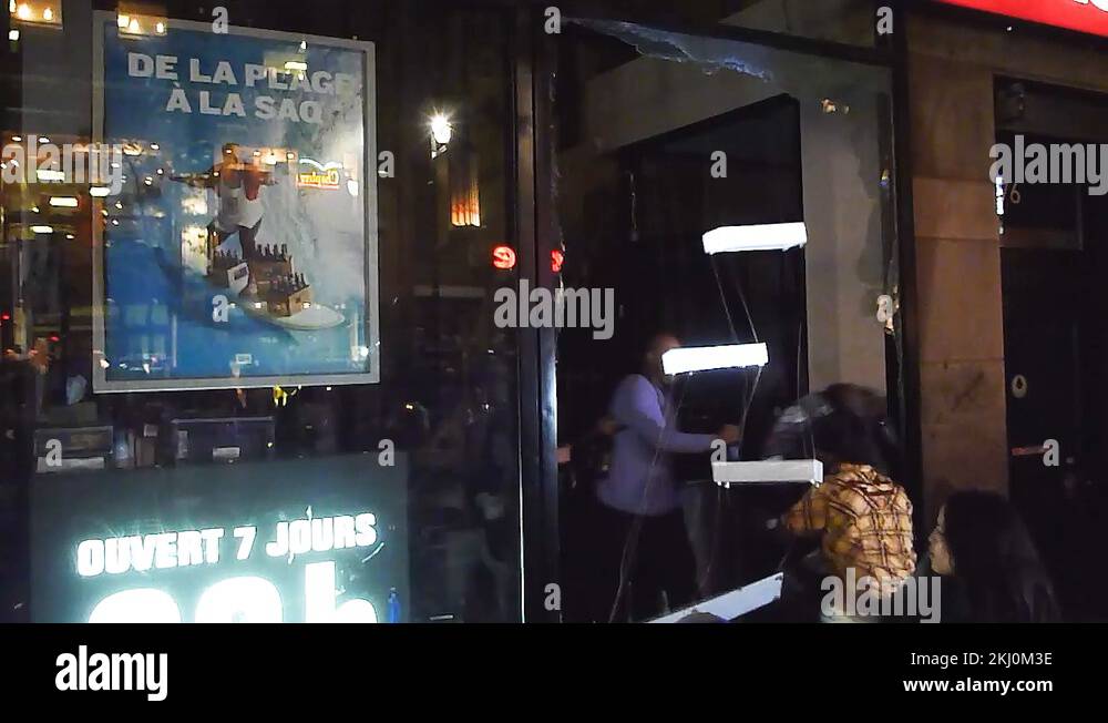 Thugs looting liquor store and stealing bottles of liquor while girl