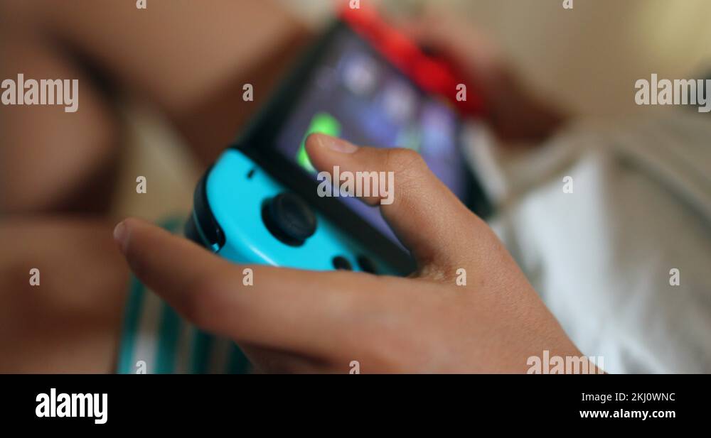 Child playing game on device. Young boy absorbed addicted to videogame