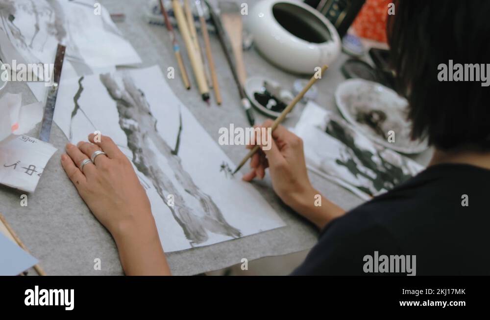 Women hands painting Japanese style. Traditional Japanese calligraphy