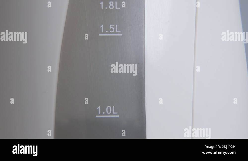 Extreme closeup of water raising up inside the kettle. Pouring of