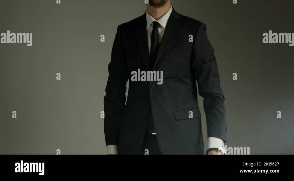 Man in business suit with briefcase handcuffed to wrist points