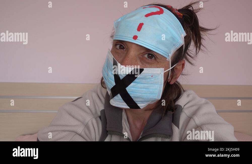 Demonstrative glance of woman in masks with question and cross marks