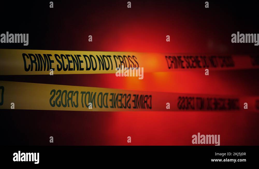 Yellow ribbons encloses crime scene, fog in the background lit by ...