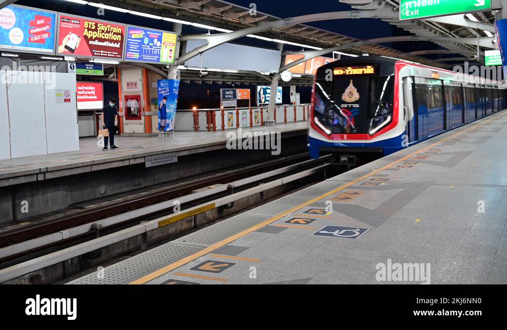 4K Trains arrive at platform with passenger wear face mask at station