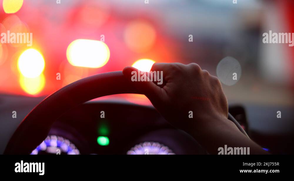 Commuter waiting in traffic jam. Closeup hand holding steering wheel stuck i Stock Video