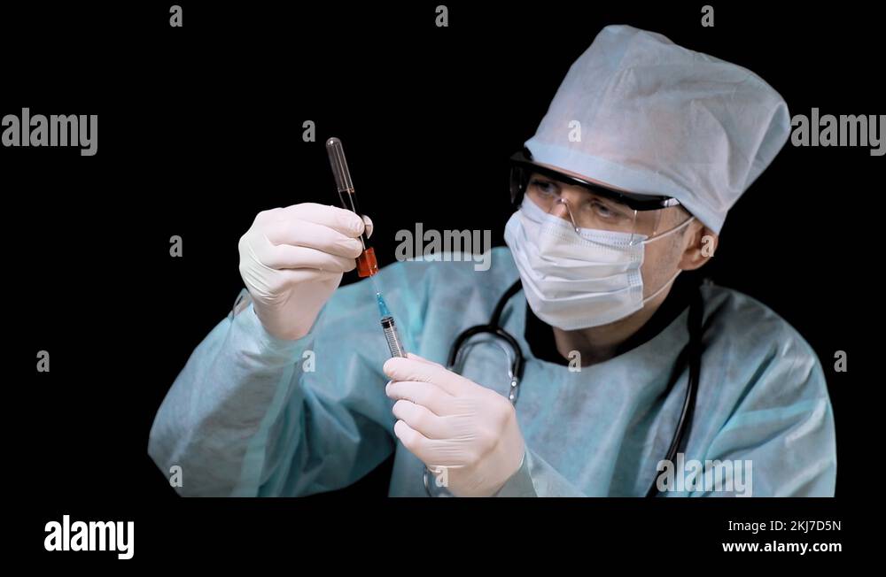 Doctor in the laboratory, draws blood from a test tube into a syringe
