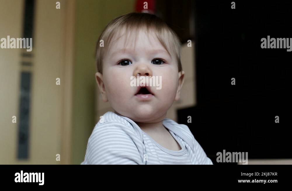 little emotional caucasian boy infant looking at the camera with brown