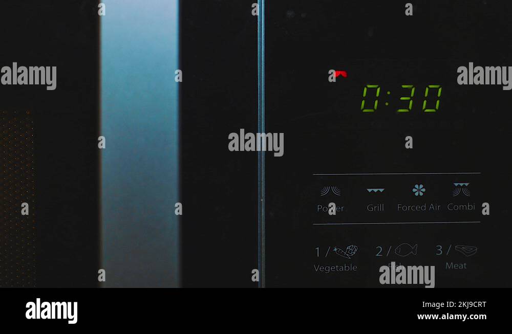 Heating food in a Microwave, countdown timer close up Stock Video