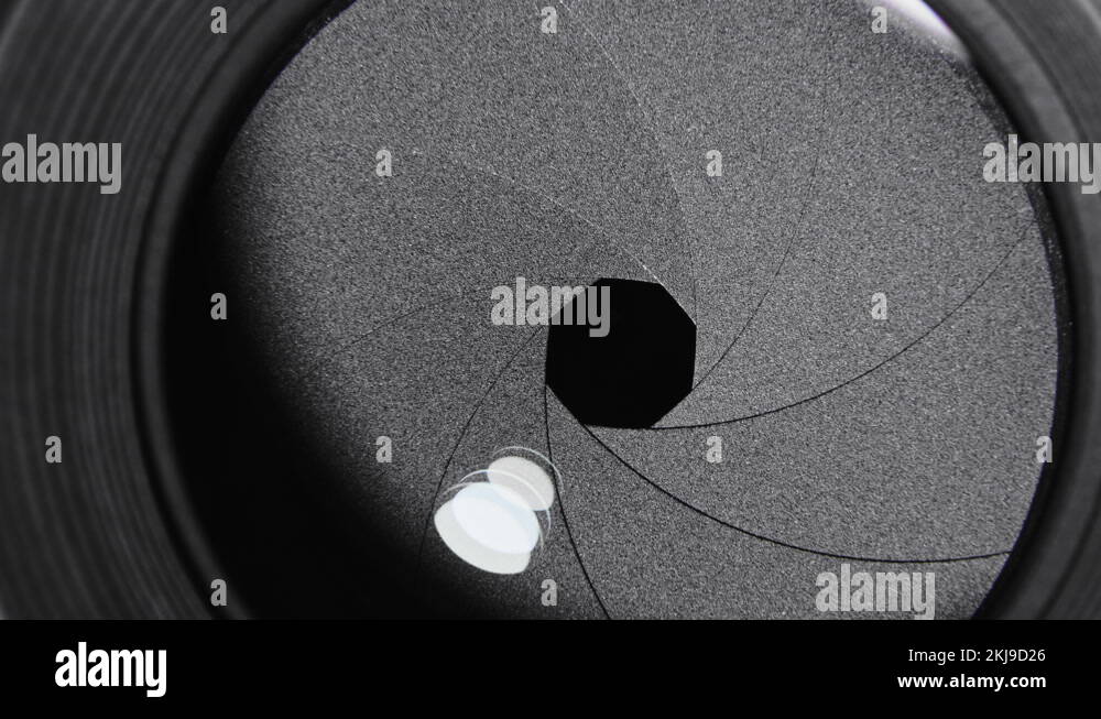 Adjusting aperture on camera lens. Close up view. Iris blades open and close Stock Video Footage