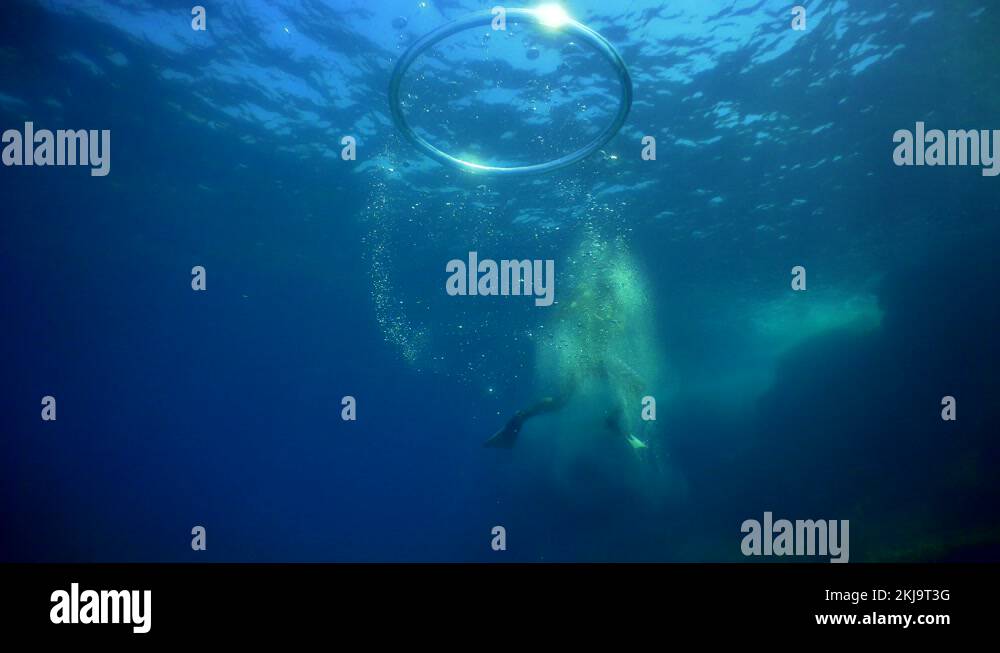 Diver Blow Bubble Rings while Freediving Cape Palos Cartagena Murcia