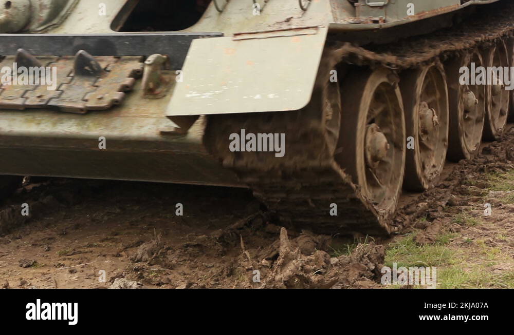 Two Armoured military Tanks driving past. Close up on Tracks. War scene