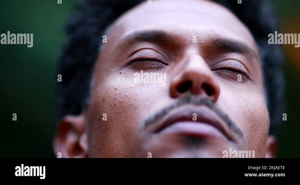 Man closing eyes in meditation and contemplation outside in nature
