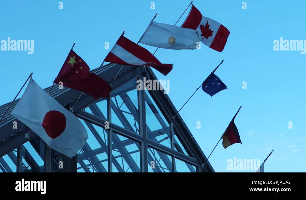 National flags on a roof, assembly or meeting of multiple nations Stock
