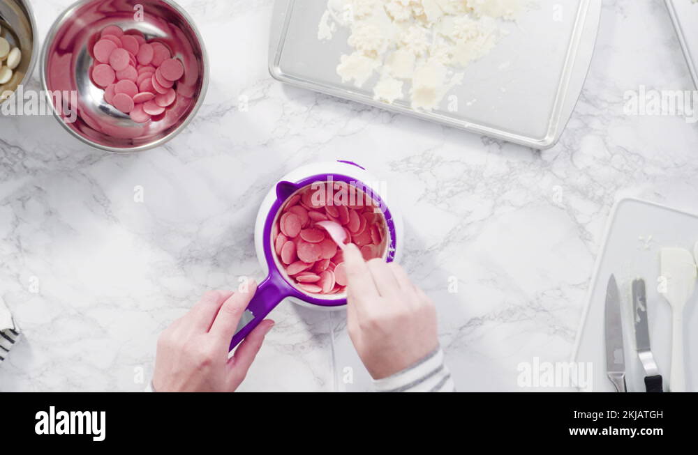 Melting chocolate candy melts in an electric candy melting pot Stock Video Footage Alamy