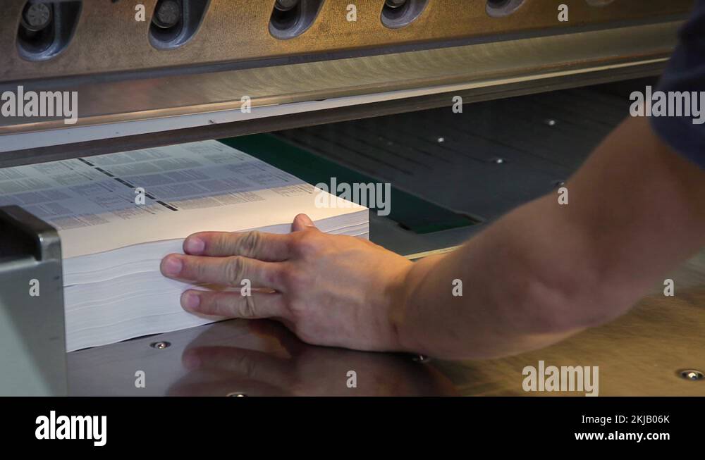 Cutting off the edges of a books in a printing press Stock Video