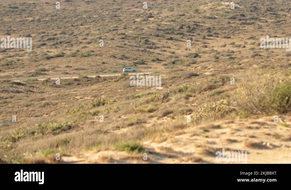 car rolling over the outback in the midlle of desert Stock Video