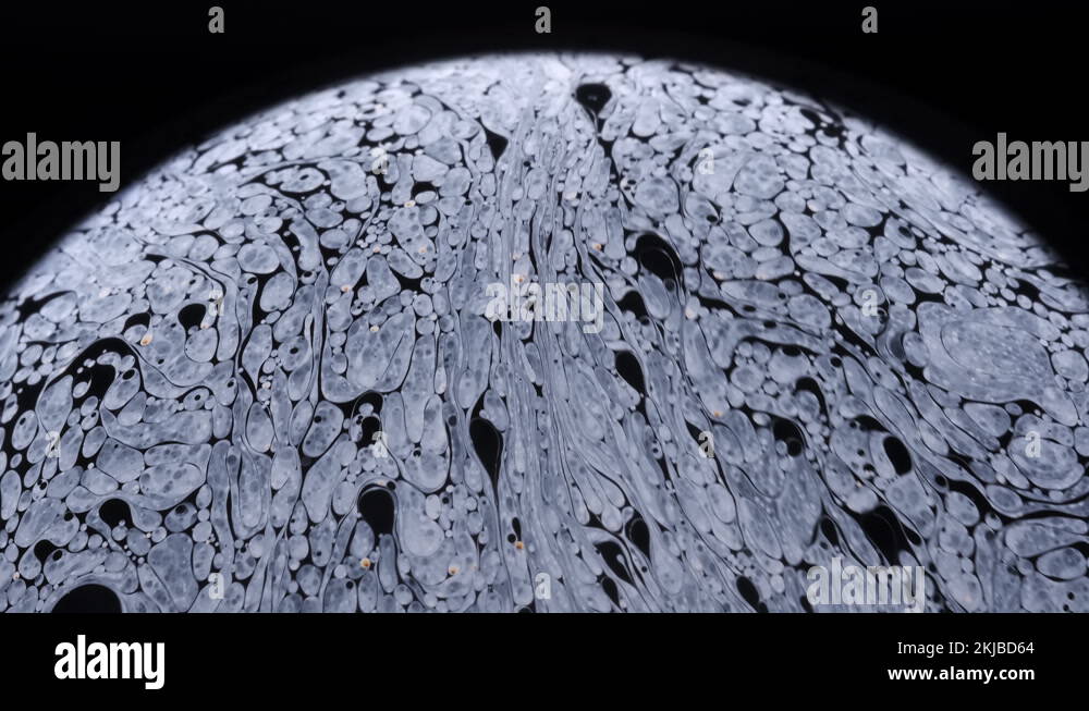 Closeup footage of the surface of a soap bubble as it begin to break