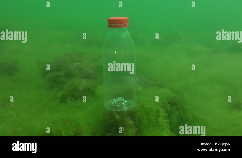 Plastic pollution of the sea PVC bottle slowly sinks to the bottom